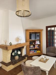a living room with a fireplace and a table at Maison familiale à Fouras-Plage & centre à pied in Fouras