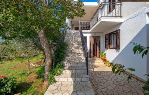 a stairway leading up to a house with a tree at Holiday home - Apartments Marinjo in Stinica