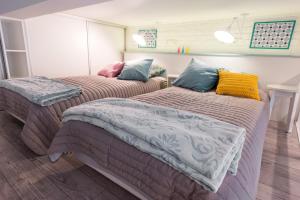 1 dormitorio con 2 camas con almohadas en Cheerful Air Conditioned Apartment with mezzanine and Parking - Old Town, en Cracovia