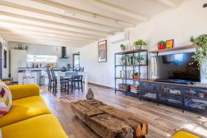 a living room with a couch and a table at Modern comforts and rustic charm in Guillena