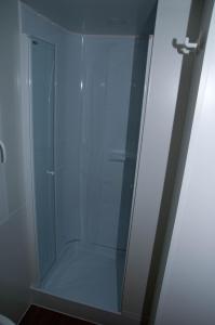 a shower stall with a glass door in a bathroom at Kamp Rujno in Starigrad +51 photos