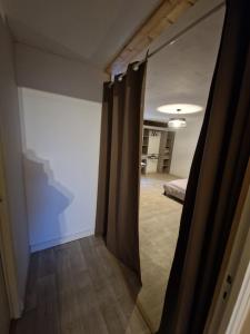 a hallway with a door open to a room at Appartement chez Sarah in Champdivers