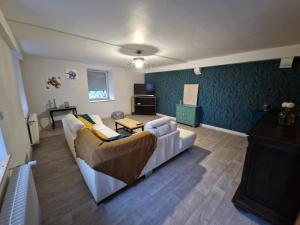 a living room with a couch and a table at Appartement chez Sarah in Champdivers