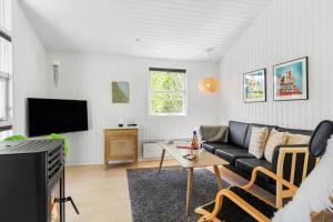 JerupにあるTV1446-Jerup-Bugten-30のソファとテレビのあるリビングルーム