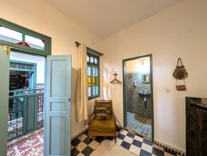 a room with a bathroom with a sink and a mirror at Aghata Palms Riad in Essaouira