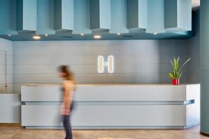 a woman walks past a counter in a lobby at Hesperia Sant Joan in Sant Joan Despí +55 photos