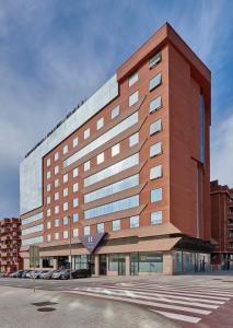 a large brick building with a lot of windows at Hesperia Sant Joan in Sant Joan Despí