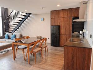 a kitchen and living room with a table and chairs at Westlake view condominium in Hanoi