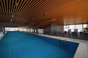 a swimming pool in a building with chairs and a swimming pool at Westlake view condominium in Hanoi