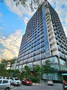 a large building with cars parked in a parking lot at Westlake view condominium in Hanoi