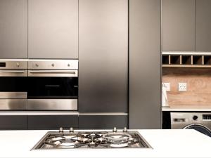 a kitchen with stainless steel appliances and a stove at Sou House in Louis Trichardt