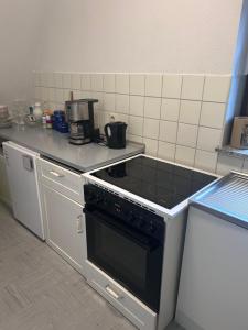 a kitchen with a black stove top oven at Jacky Wohnung in Schonwald im Schwarzwald