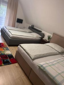 two beds sitting in a room with at Jacky Wohnung in Schonwald im Schwarzwald