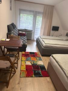 a living room with a bed and a rug at Jacky Wohnung in Schonwald im Schwarzwald