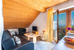 a living room with a couch and a table at Ferienhof Siber in Owingen