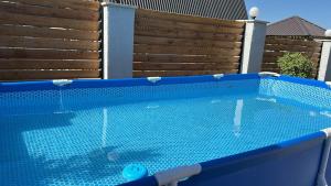 a swimming pool in front of a wooden fence at A-frame evlər-II in Qusar