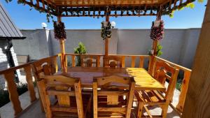 a wooden table and chairs on a patio at A-frame evlər-II in Qusar