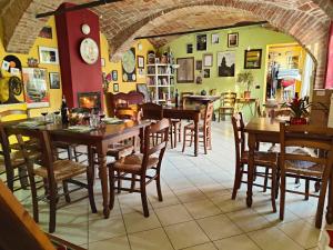 a dining room with wooden tables and chairs at Cascina Il Convivio in Diano dʼAlba