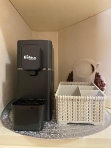 a coffee maker and a basket on a table at B&B La Casa Mè in Francavilla al Mare