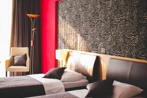 Postel nebo postele na pokoji v ubytování ZOO hotel