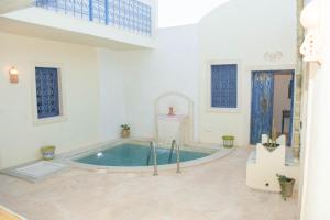 a large bathroom with a jacuzzi tub at Dar El Hara in Houmt Souk