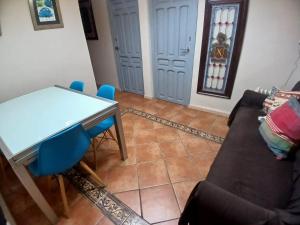 a living room with a table and a couch at Budget and lovely rooms Macarena B in Seville