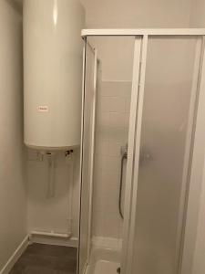 a shower with a glass door in a bathroom at T2 Meublé, Équipé, Parfait pour Vos Séjours in Châteaumeillant