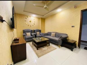 a living room with a couch and a tv at Awais real estate in Rawalpindi