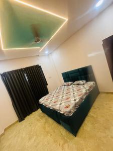 a bedroom with a bed with a black bed frame at Gentle breeze farm house in Venkatāpur