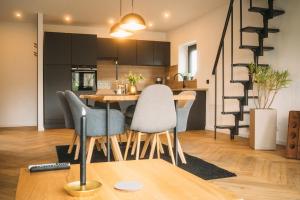 a kitchen and dining room with a table and chairs at Ferienhaus Schöne Aussicht Schwarz in Edertal