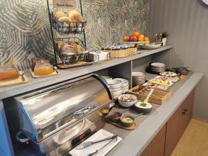 a breakfast buffet with food on a counter at Gościniec nad Olzą in Cieszyn +31 photos