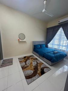 a bedroom with a blue bed and a large window at Singgah homestay in Gua Sai