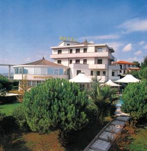 a large white building with trees in front of it at Villa Dei Romanzi in Tortoreto Lido