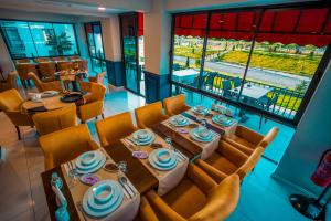 a dining room with a table and chairs and a view at Düzce Derdin Termal Resort & Spa in Duzce