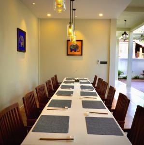 a long table in a room with chairs at Viriya Hotel in Luang Prabang