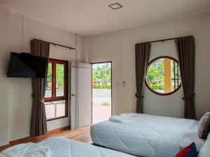 a bedroom with two beds and a large window at My Heaven Resort Family House 