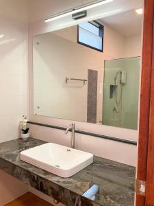 a bathroom with a sink and a mirror at My Heaven Resort Family House 