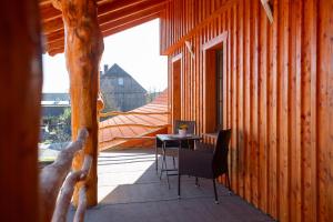 a room with a table and chairs on a porch at Lärchenhof Harz in Hasselfelde