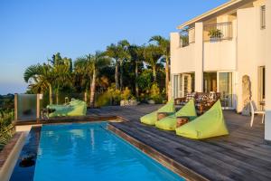 a house with a swimming pool with inflatable pillows at Nakai Beach Homestay in Trafalgar