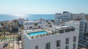 an aerial view of a building with a swimming pool at Marins Naiya Boutique Hotel in Cala Bona +64 photos