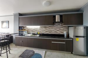 a kitchen with brown cabinets and a stainless steel refrigerator at Condo at Kandi tower 1 in Angeles