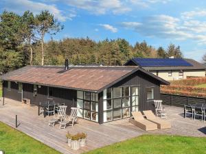a large deck with chairs and a house at 8 person holiday home in Hals-By Traum in Hals