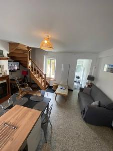 una sala de estar con un sofá y una mesa en Le Petit Noirda, en Audresselles