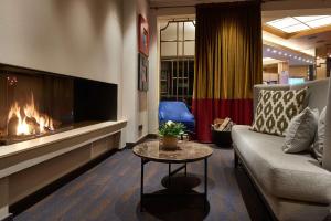 a living room with a couch and a fireplace at Best Western Plus Hotel St. Raphael in Hamburg