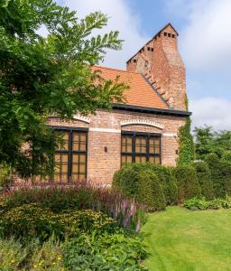 a brick building with a tower on top of it at Jonojé Luxury Suites in Bruges