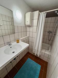a white bathroom with a sink and a shower at RheinOase mit Garten für Familien & Gruppen in Koblenz