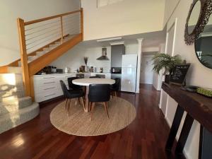 a kitchen and dining room with a table and chairs at 5@CapeView, beachfront Geographe Bay in Busselton +19 photos