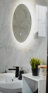 a bathroom with a sink and a mirror on the wall at Vila Elena in Gevgelija +38 photos