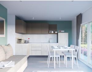 a kitchen and dining room with a table and chairs at Camping Nord in Klopein am Klopeiner See