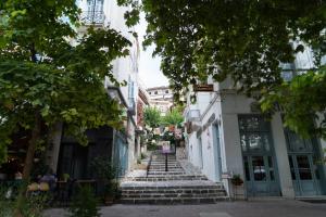 a group of stairs in a city with buildings at Luxury Apartment in Lamia in Lamía